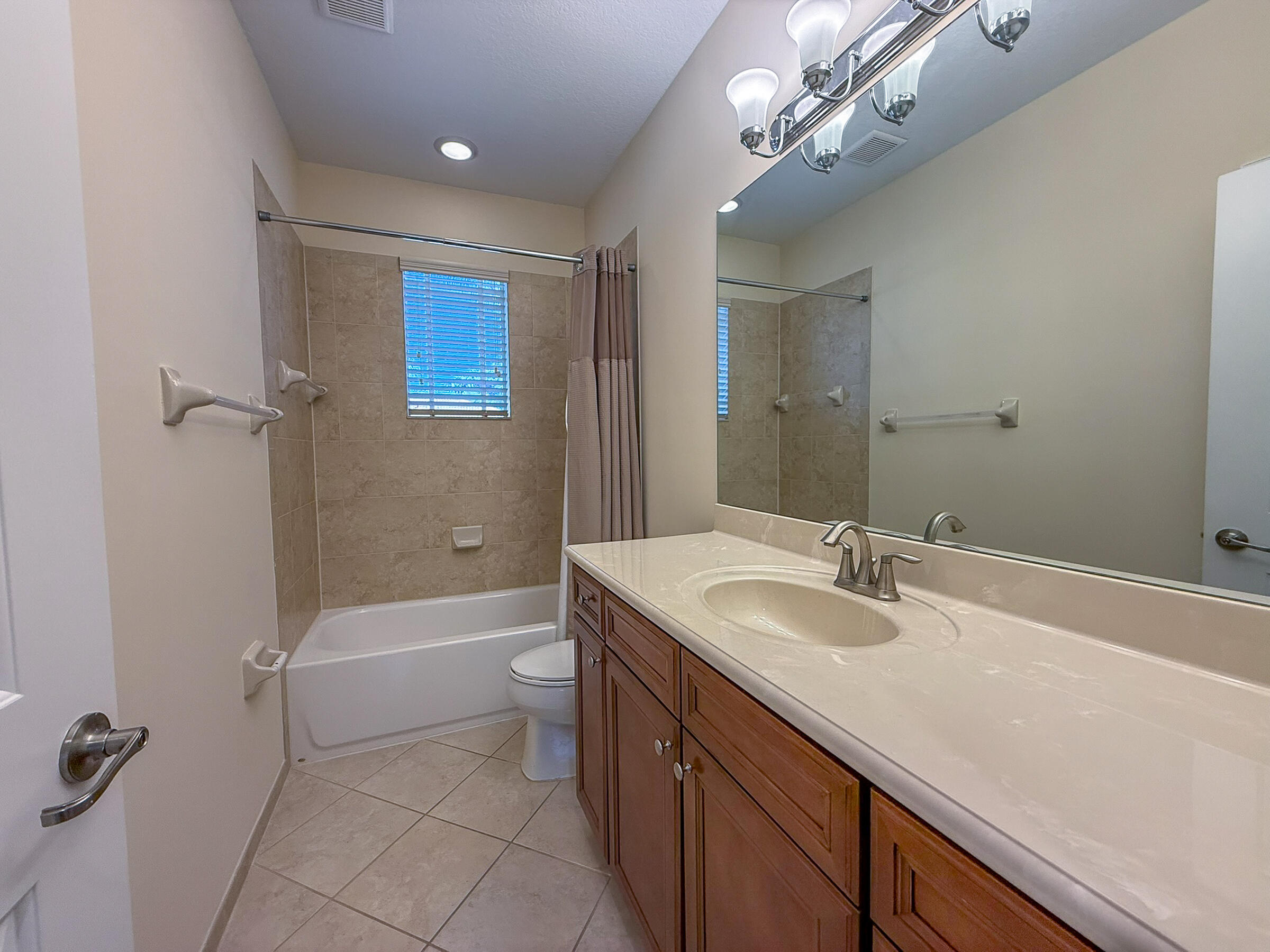 122 Northwest Gardner Street Boca Raton, FL 33432 - Photo 17 of 34 a bathroom with a granite countertop sink a toilet and shower