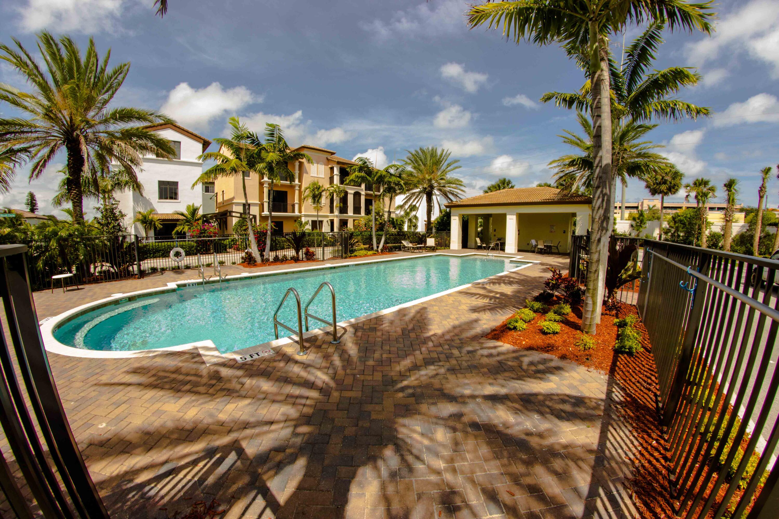122 Northwest Gardner Street Boca Raton, FL 33432 - Photo 2 of 34 a view of a house with a swimming pool and sitting area