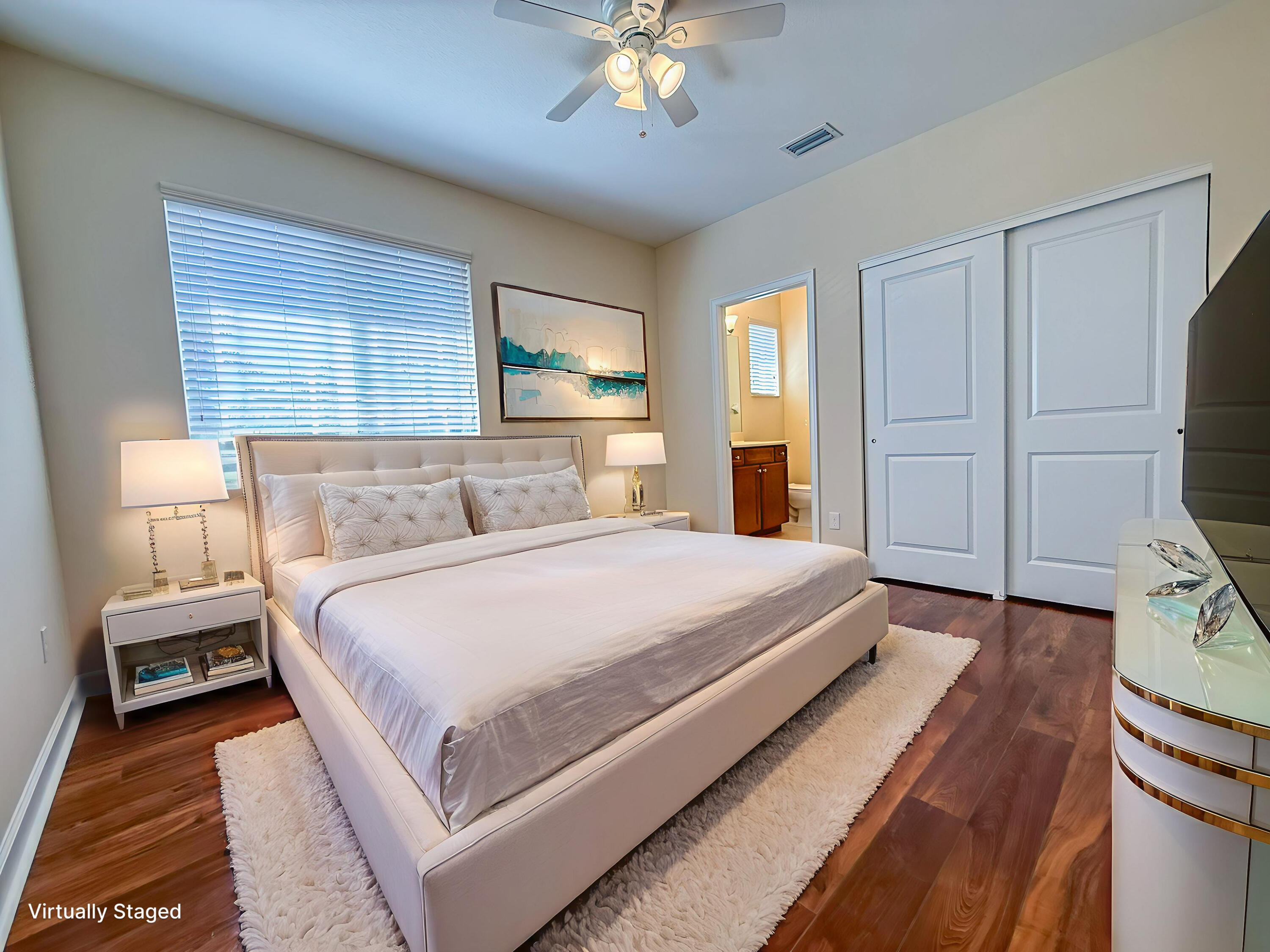 122 Northwest Gardner Street Boca Raton, FL 33432 - Photo 22 of 34 a bedroom with a large bed and a chandelier