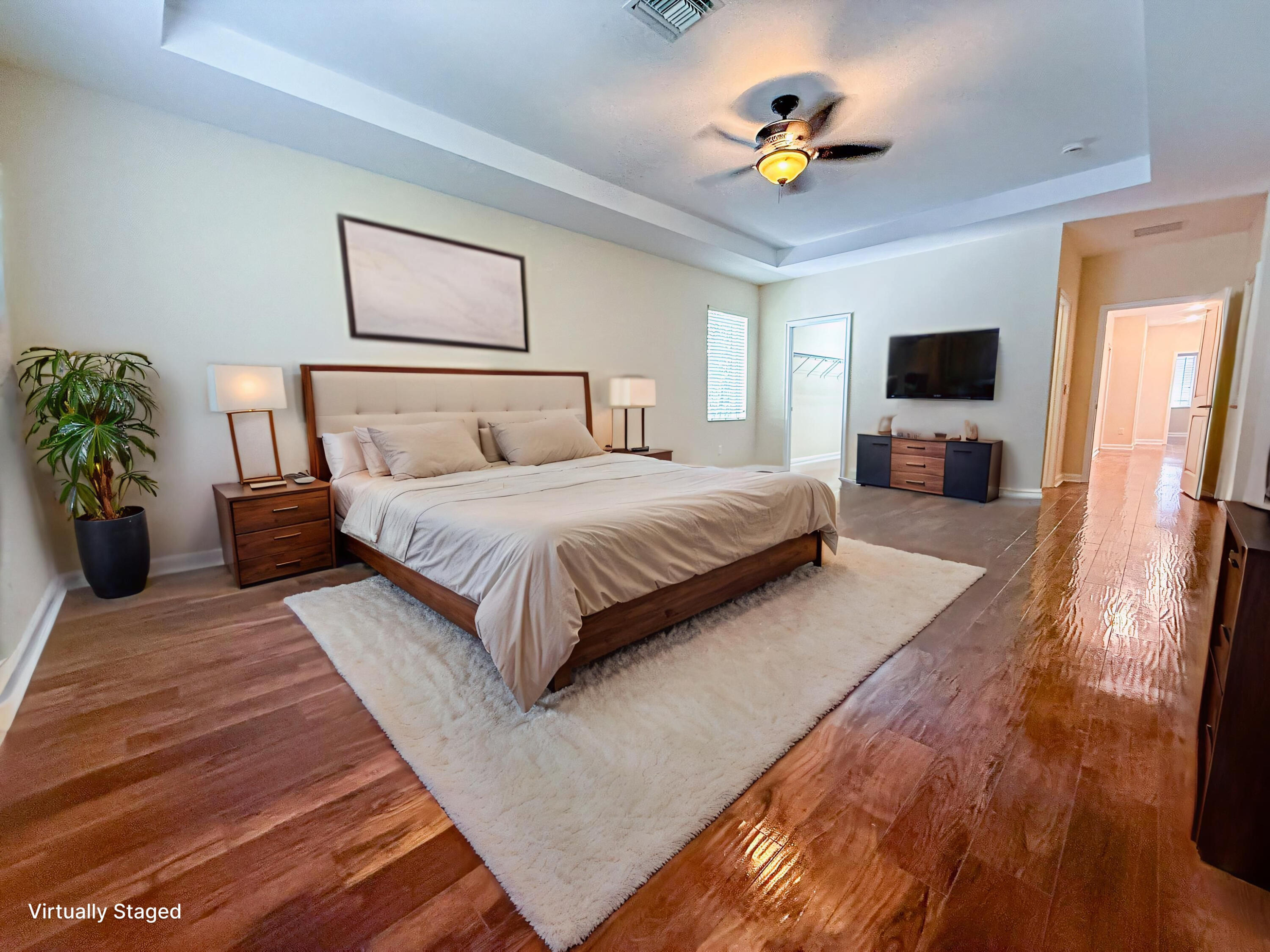 122 Northwest Gardner Street Boca Raton, FL 33432 - Photo 28 of 34 a bedroom with a bed a couch and a flat screen tv