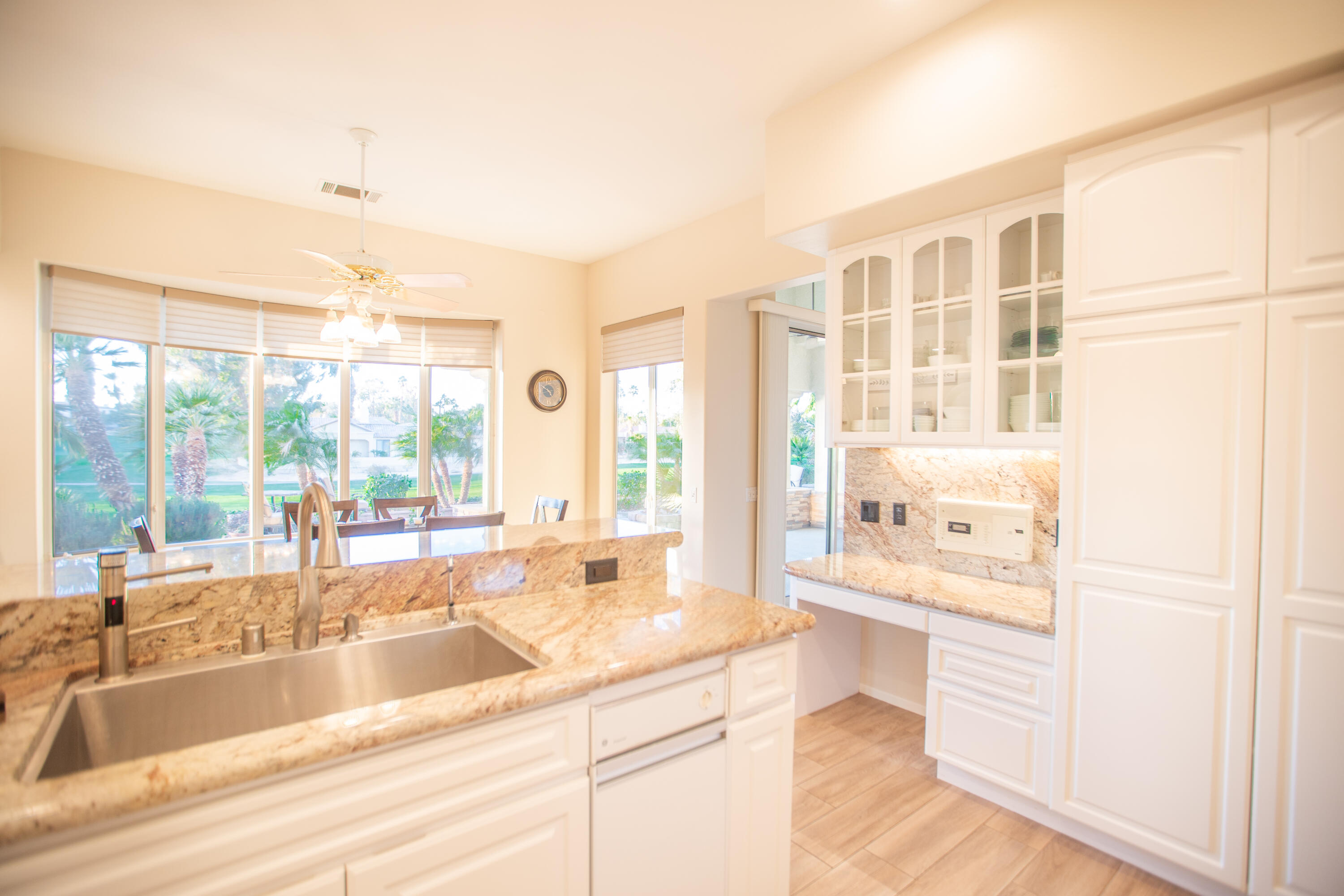 79740 Ryan Way Bermuda Dunes, CA 92203 - Photo 22 of 43 a large kitchen with kitchen island a large window in it