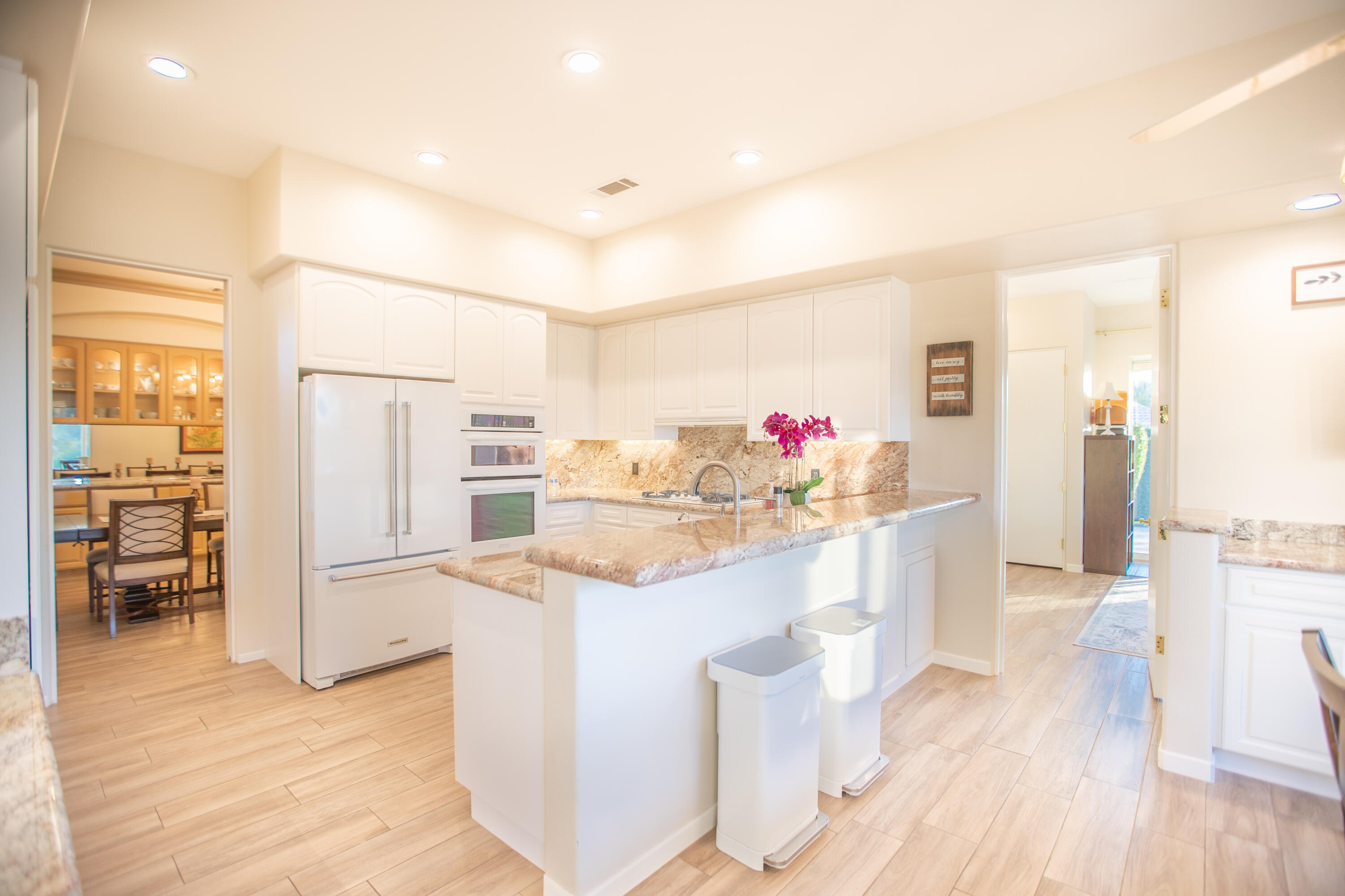 79740 Ryan Way Bermuda Dunes, CA 92203 - Photo 23 of 43 a kitchen with stainless steel appliances cabinets and wooden floor