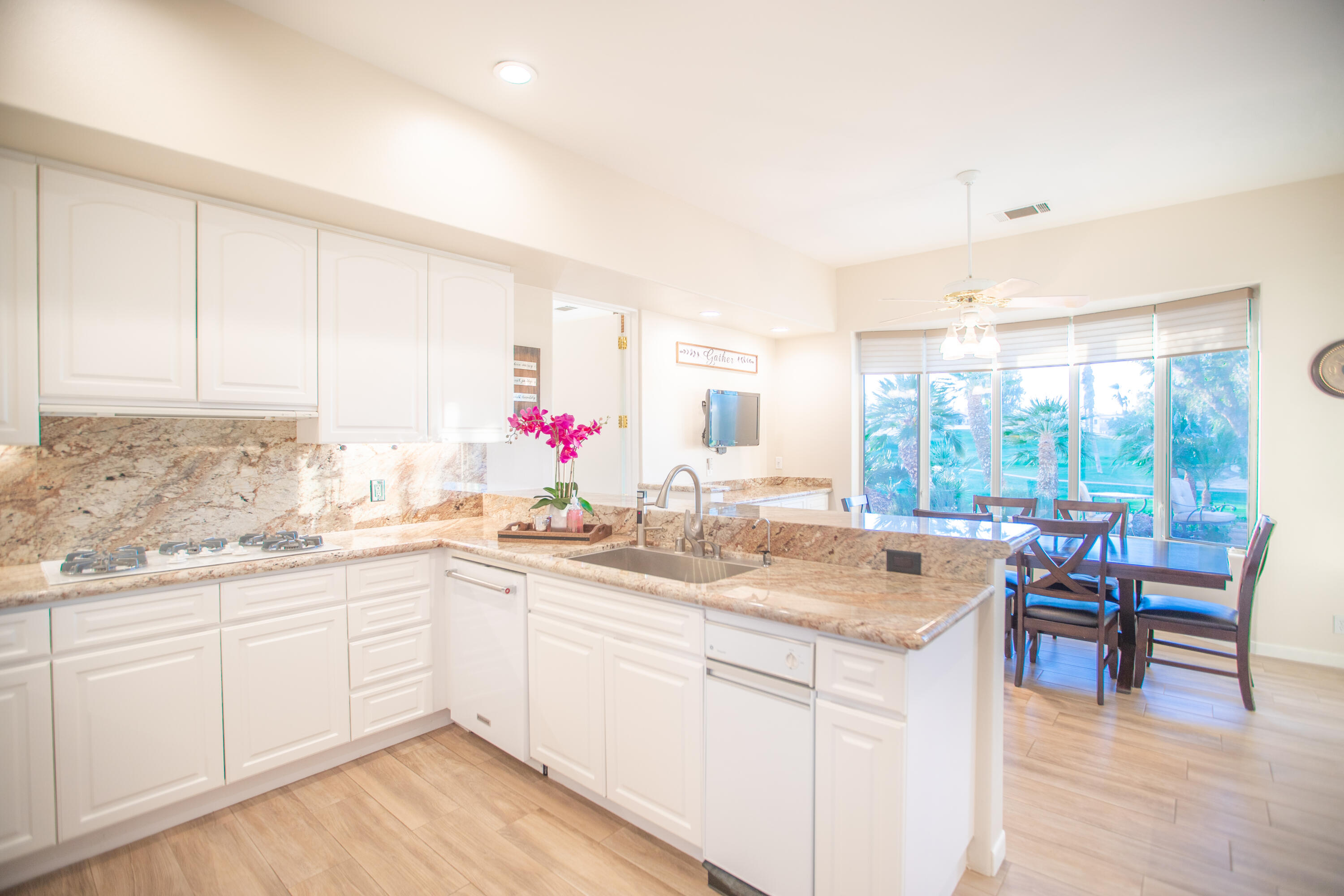 79740 Ryan Way Bermuda Dunes, CA 92203 - Photo 24 of 43 a kitchen with sink cabinets and dining table chair