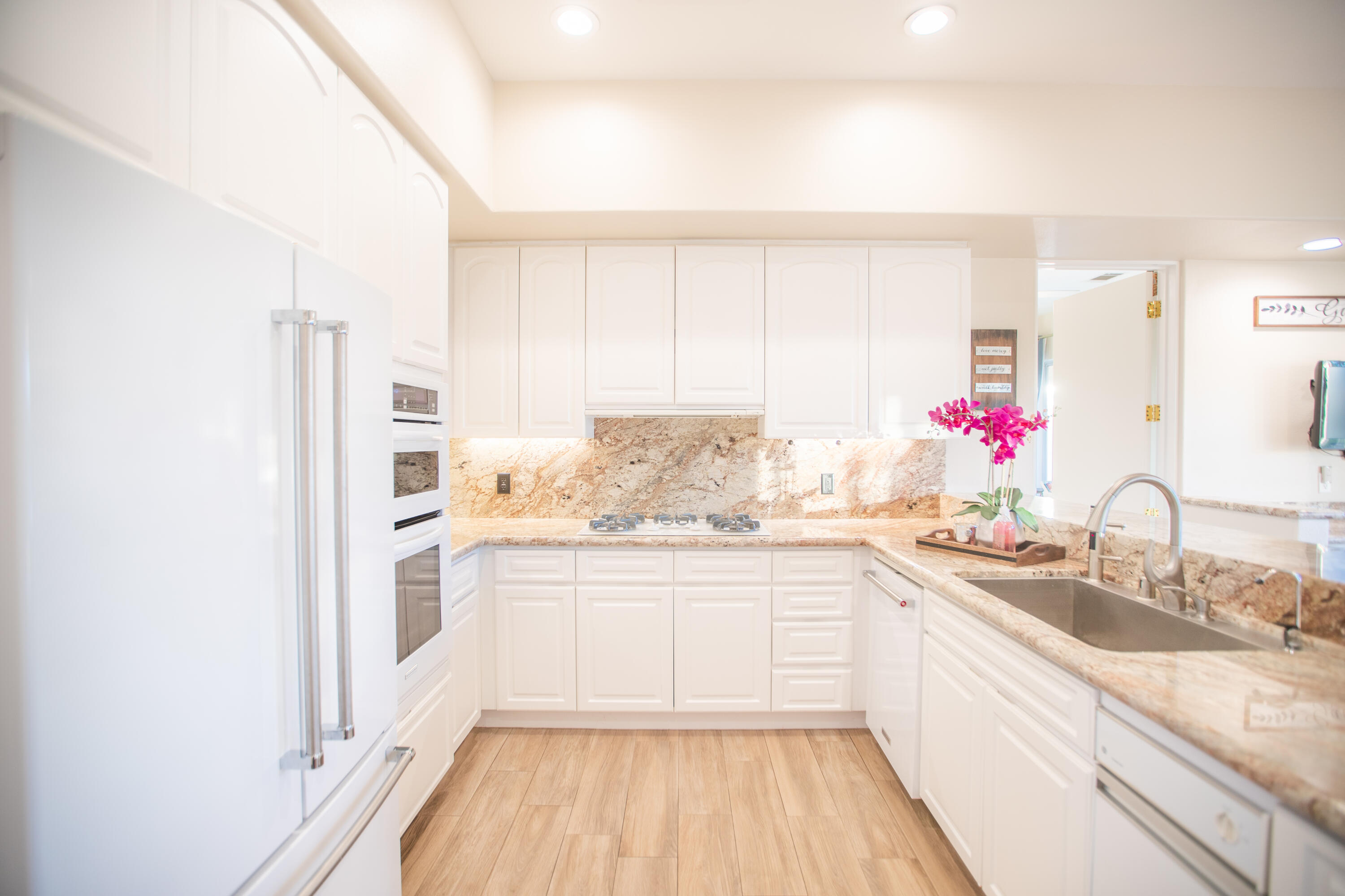 79740 Ryan Way Bermuda Dunes, CA 92203 - Photo 25 of 43 a kitchen with kitchen island granite countertop a sink cabinets and stainless steel appliances