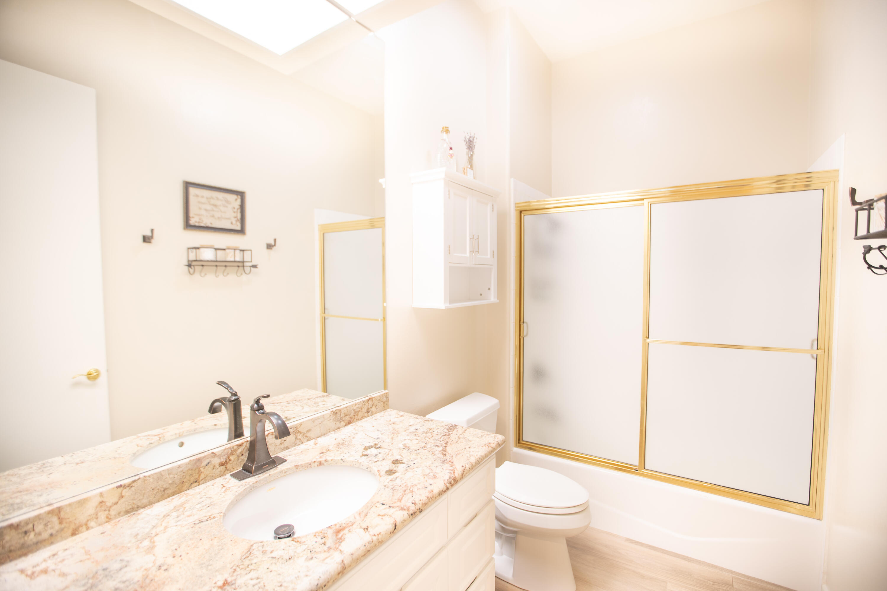 79740 Ryan Way Bermuda Dunes, CA 92203 - Photo 35 of 43 a bathroom with a granite countertop sink a toilet and a mirror