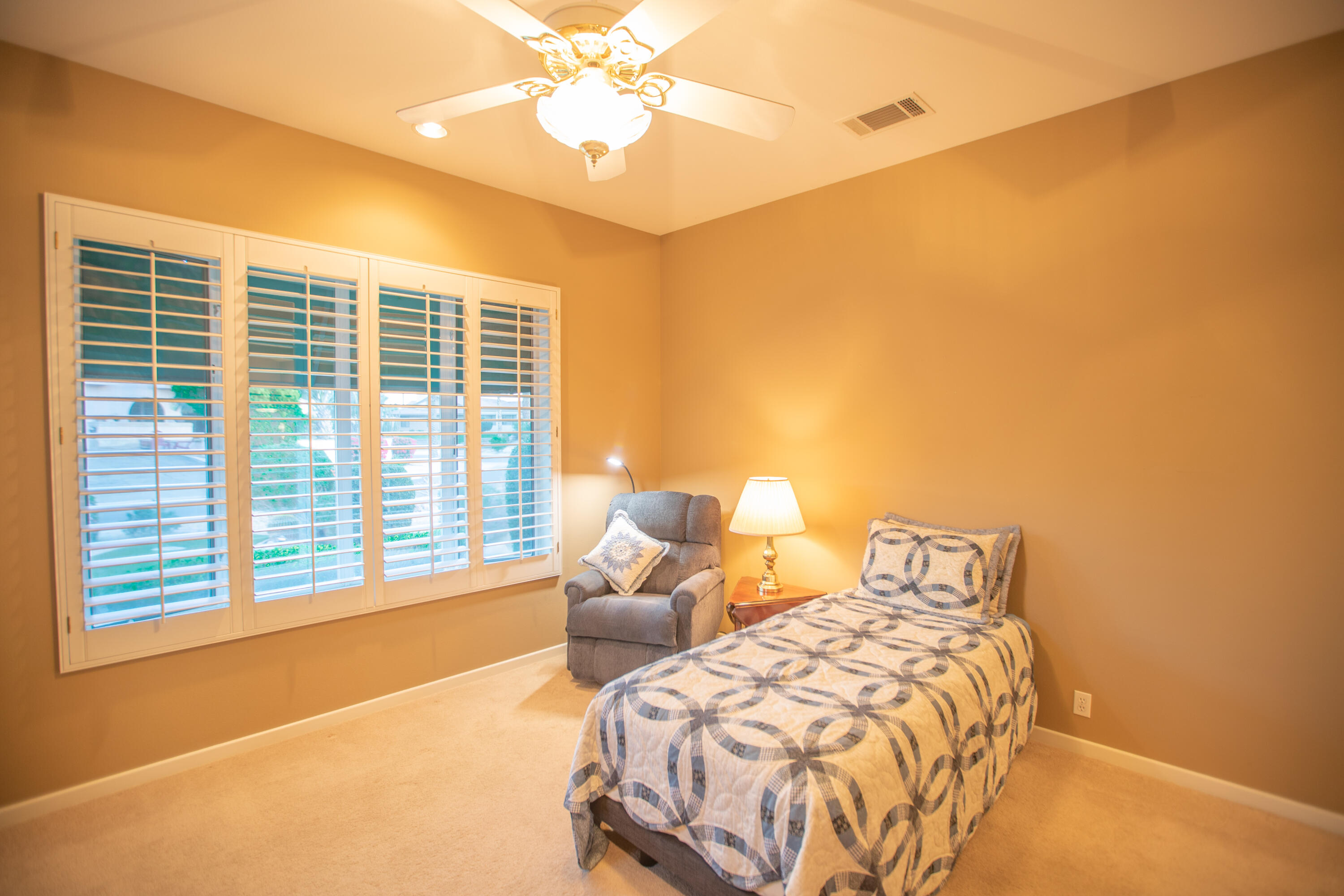 79740 Ryan Way Bermuda Dunes, CA 92203 - Photo 36 of 43 a bedroom with a bed and a chandelier