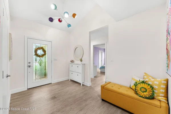 a view of a dining room with furniture and chandelier