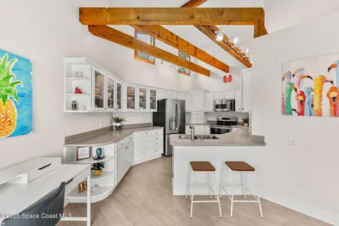 a kitchen with stainless steel appliances granite countertop a sink and white cabinets