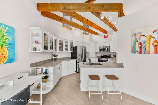 a kitchen with stainless steel appliances granite countertop a sink and white cabinets