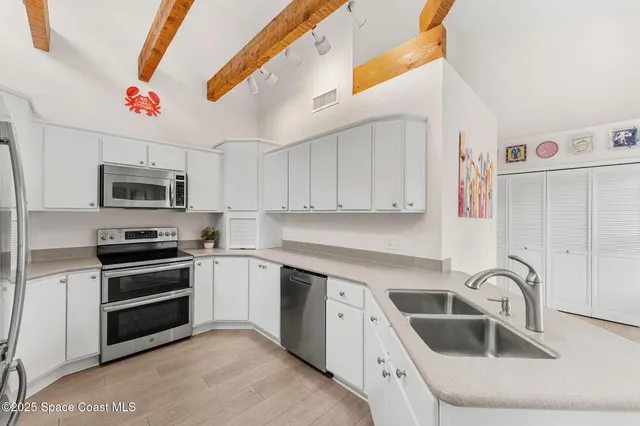 a kitchen with a refrigerator and a sink