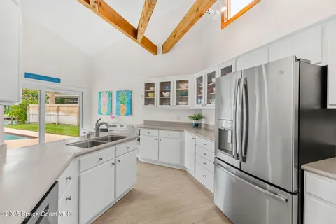 a kitchen with a sink and white cabinets