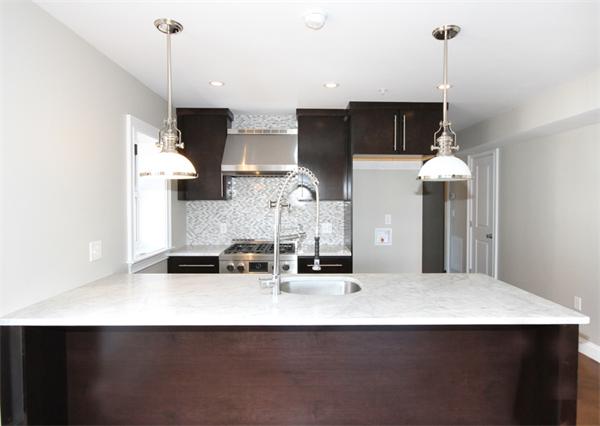 9 North Margin Street Boston, MA 02113 - Photo 12 of 19 a kitchen with stainless steel appliances a sink a refrigerator a stove a microwave and cabinets