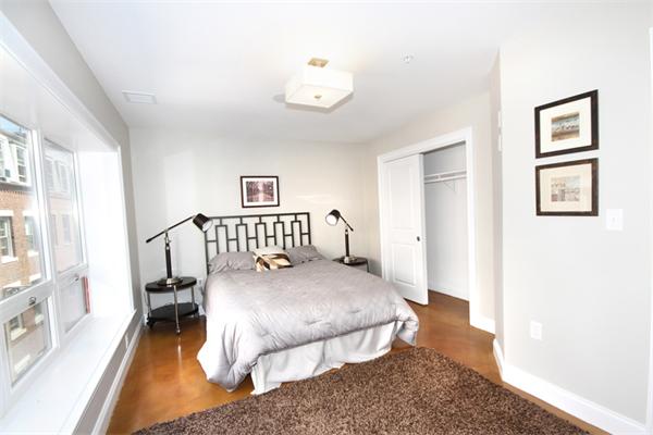 9 North Margin Street Boston, MA 02113 - Photo 17 of 19 a bedroom with a bed chandelier and a window