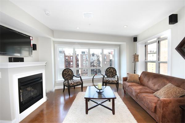 9 North Margin Street Boston, MA 02113 - Photo 4 of 19 a living room with furniture a fireplace and a flat screen tv