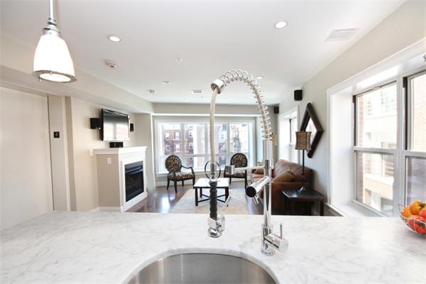9 North Margin Street Boston, MA 02113 - Photo 10 of 19 a kitchen with stainless steel appliances kitchen island granite countertop a sink and a refrigerator