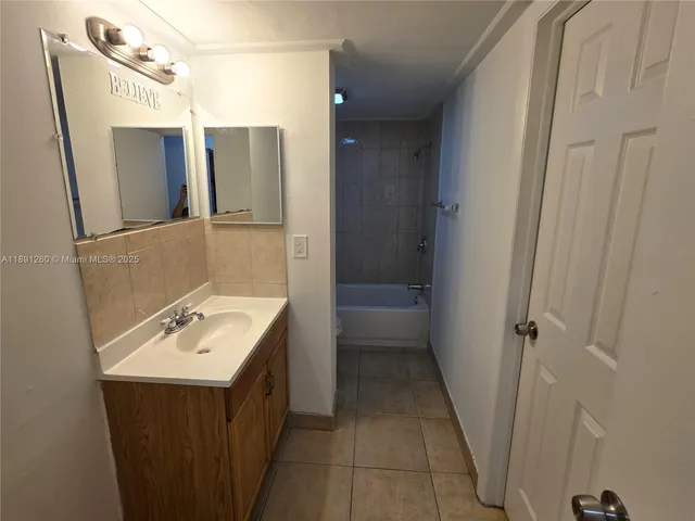 a bathroom with a sink a mirror and a shower