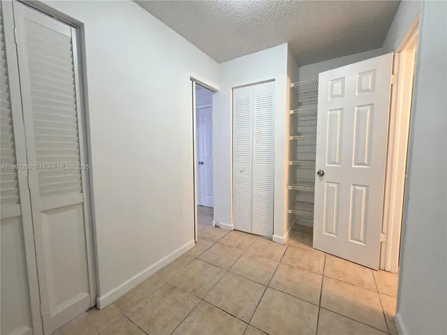 a view of an empty room with closet area