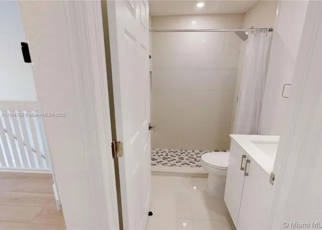 a bathroom with a sink toilet and mirror