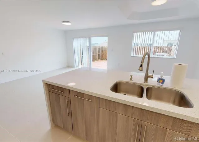 a kitchen with a sink and a window