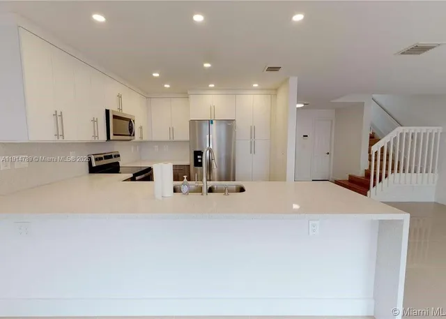 a large kitchen with stainless steel appliances