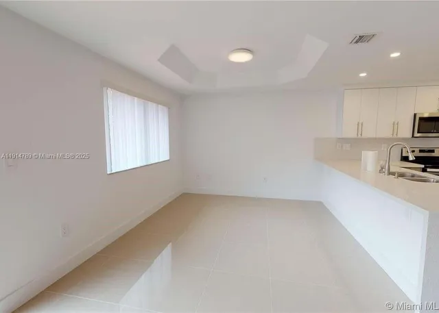 a view of a kitchen with a sink and a window