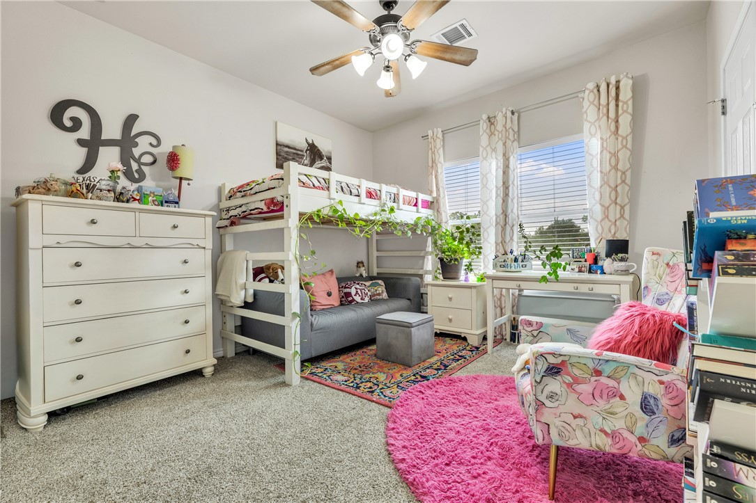 1425 West Villa Maria Road, Unit 1004 Bryan, TX 77801 - Photo 19 of 23 a living room with furniture and a potted plant