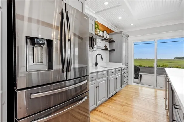 a kitchen with white cabinets and white appliances