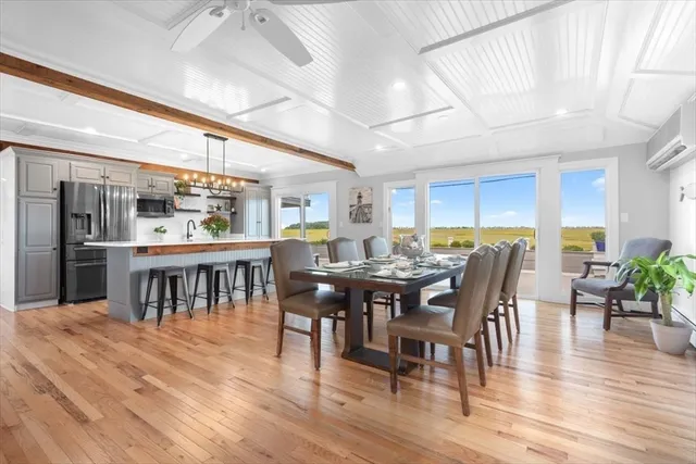 a view of a dining room with furniture window and wooden floor