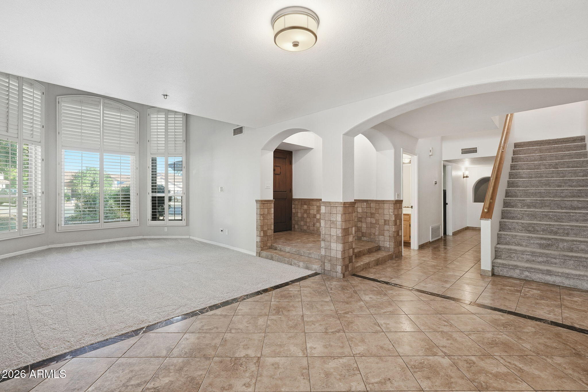 17002 South 34th Place Phoenix, AZ 85048 - Photo 11 of 27 a view of a livingroom with furniture and staircase
