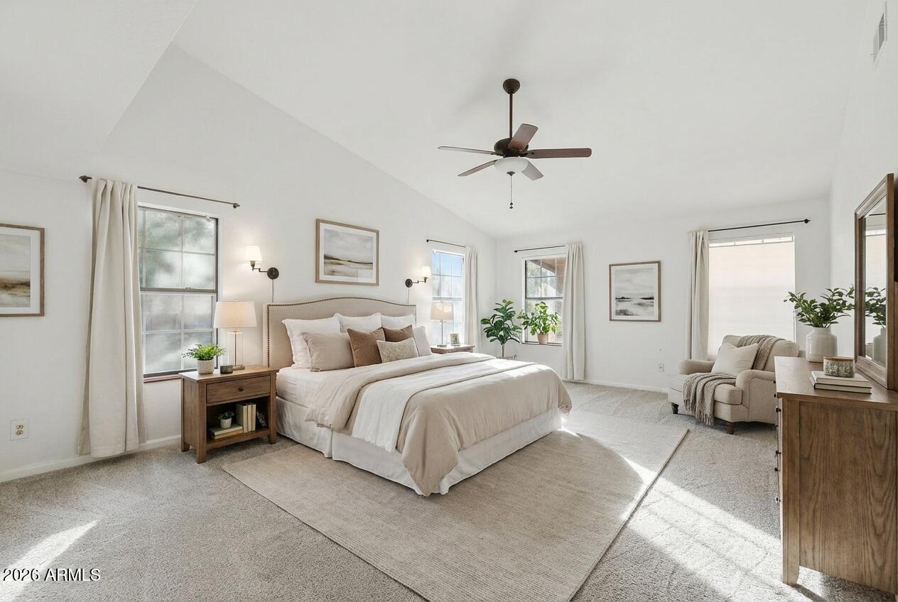 17002 South 34th Place Phoenix, AZ 85048 - Photo 13 of 27 a spacious bedroom with a bed a chandelier and windows