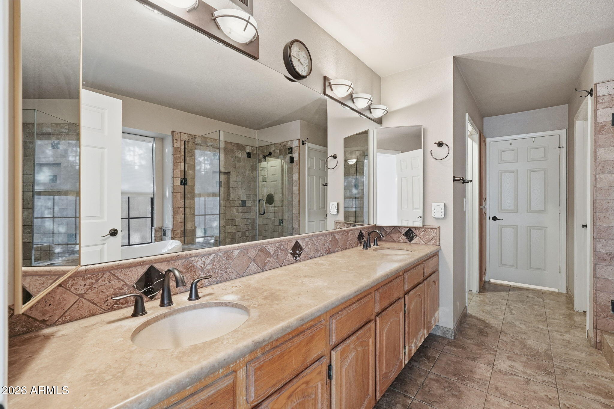 17002 South 34th Place Phoenix, AZ 85048 - Photo 14 of 27 a bathroom with double vanity sinks and a large mirror