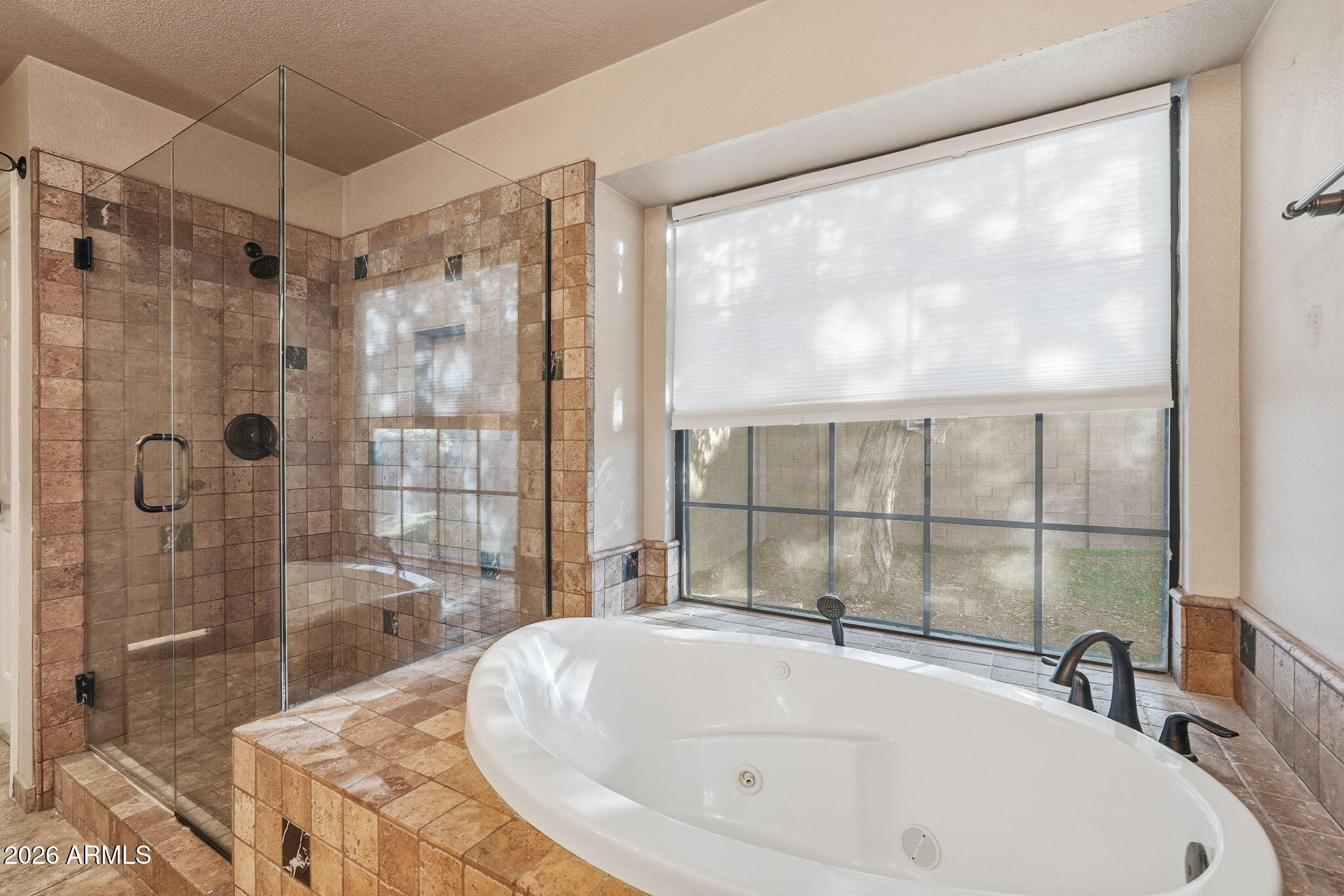 17002 South 34th Place Phoenix, AZ 85048 - Photo 15 of 27 a bathroom with a tub and a shower