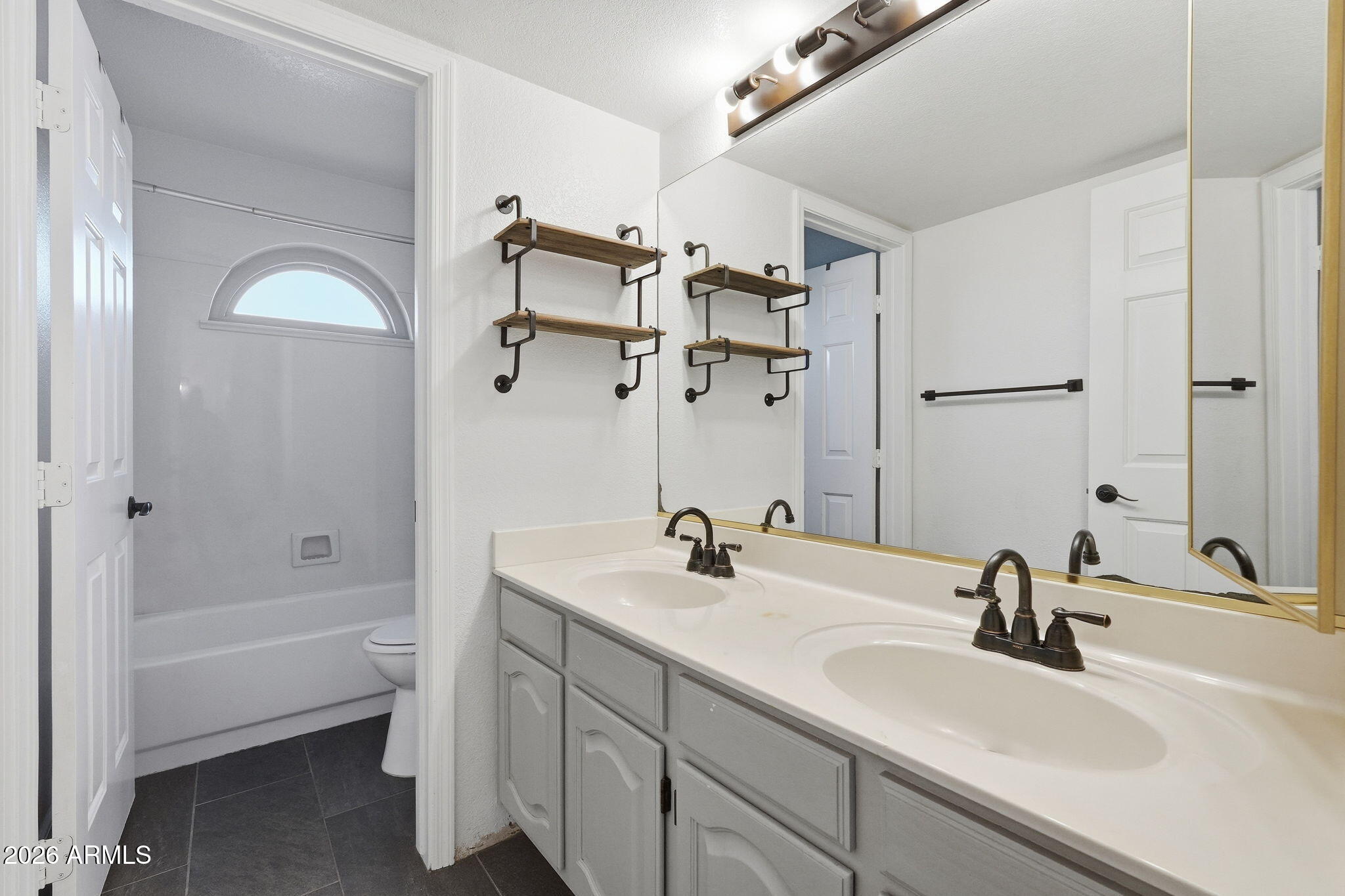 17002 South 34th Place Phoenix, AZ 85048 - Photo 18 of 27 a bathroom with a sink and a mirror