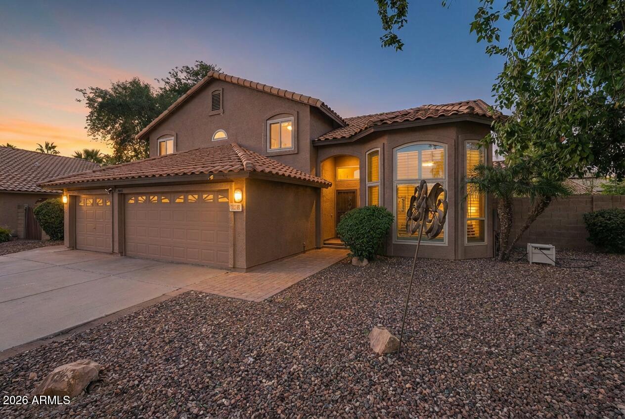 17002 South 34th Place Phoenix, AZ 85048 - Photo 2 of 27 a front view of a house with garden