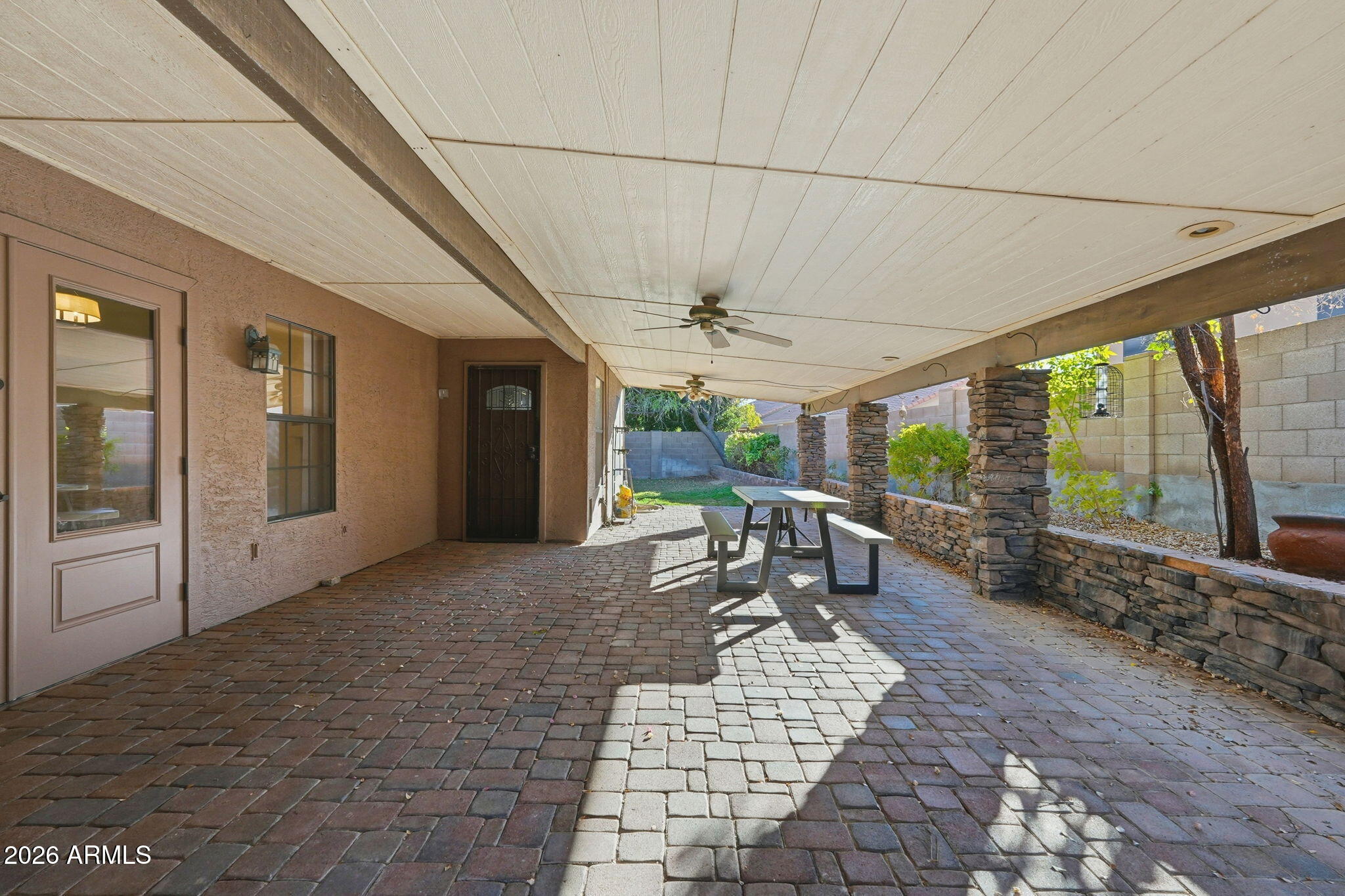 17002 South 34th Place Phoenix, AZ 85048 - Photo 23 of 27 a view of a patio with table and chairs near a yard