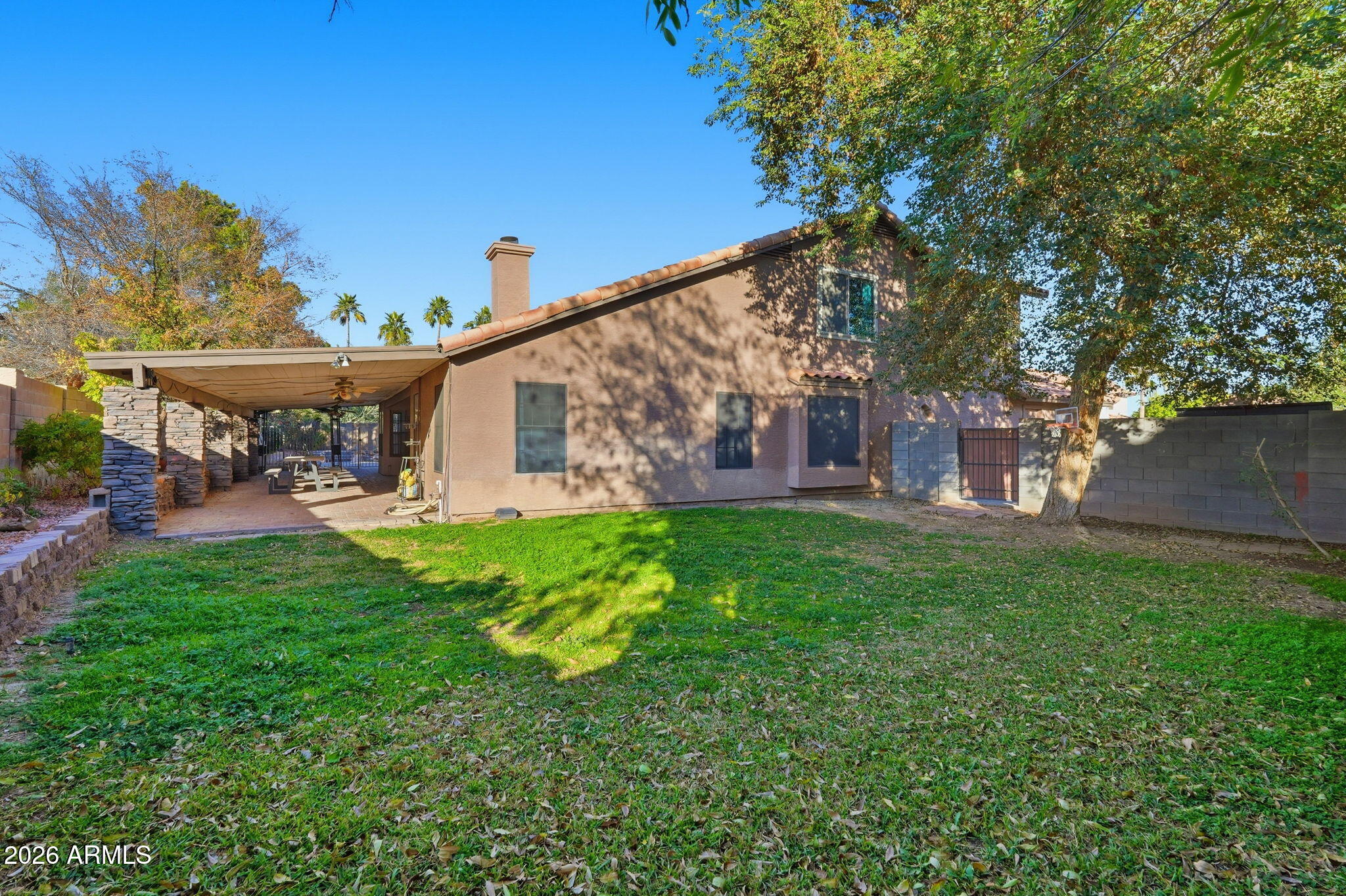 17002 South 34th Place Phoenix, AZ 85048 - Photo 27 of 27 a view of a house with a backyard porch and a garden