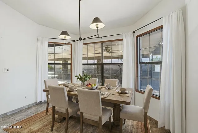 a view of a livingroom with a fireplace wooden cabinets and windows
