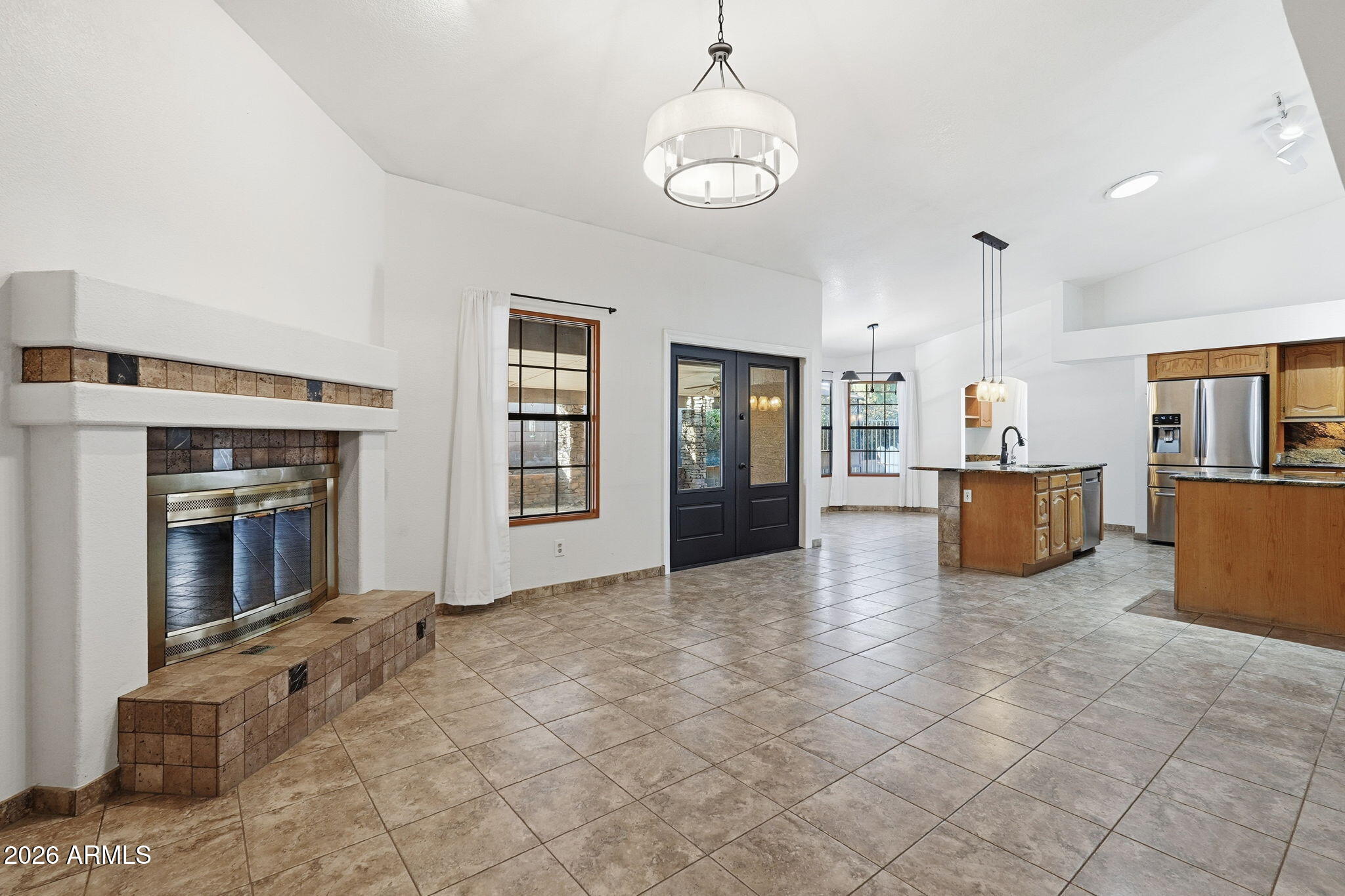 17002 South 34th Place Phoenix, AZ 85048 - Photo 9 of 27 a view of a livingroom with a fireplace wooden cabinets and windows