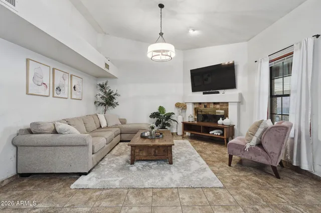a view of a livingroom with furniture and staircase