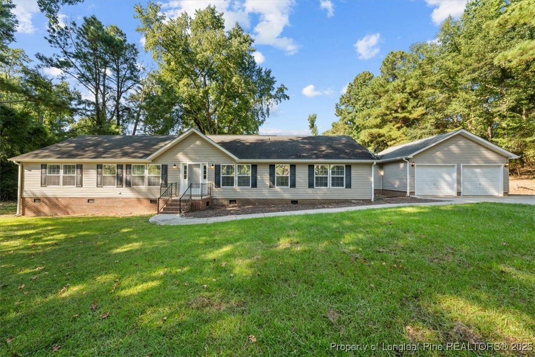 11891 Aberdeen Road Aberdeen, NC 28315 - Photo 1 of 35 a front view of a house with yard and green space