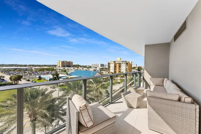 a city view from a balcony with furniture