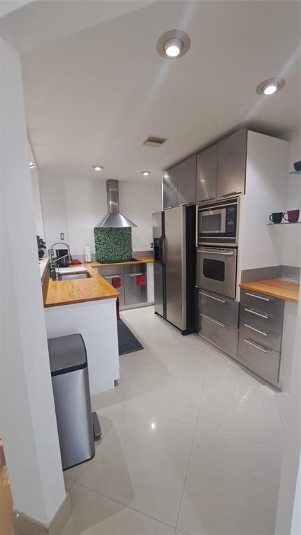 4519 Feivel Road, Unit 46 West Palm Beach, FL 33417 - Photo 11 of 56 a kitchen with stainless steel appliances a refrigerator and a stove