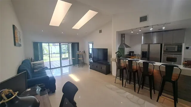 a bedroom with a bed flat screen tv and a walk in closet