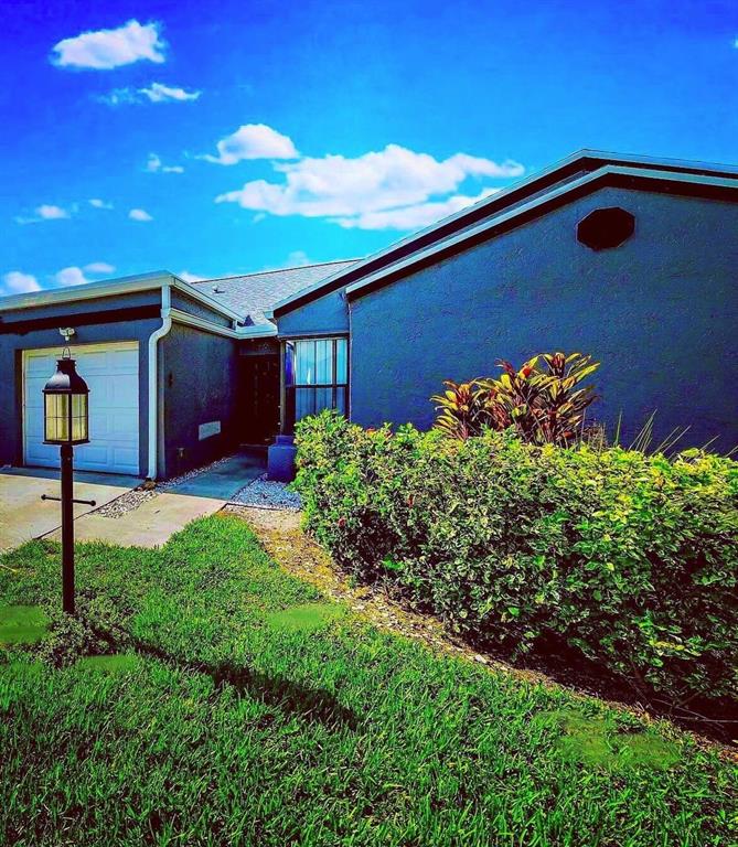 4519 Feivel Road, Unit 46 West Palm Beach, FL 33417 - Photo 2 of 56 a front view of a house with a yard