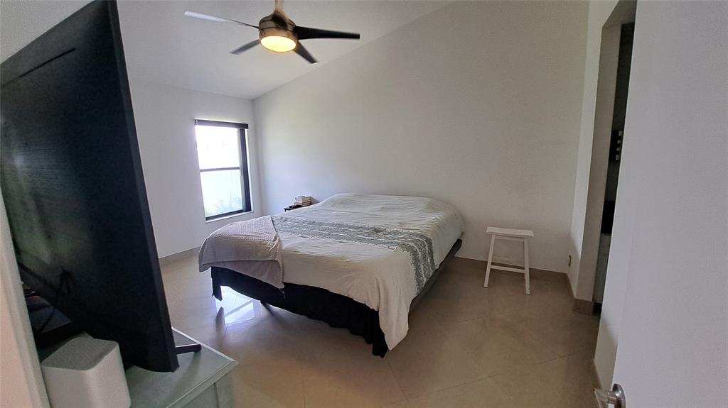 4519 Feivel Road, Unit 46 West Palm Beach, FL 33417 - Photo 22 of 56 a bedroom with a bed rug and window