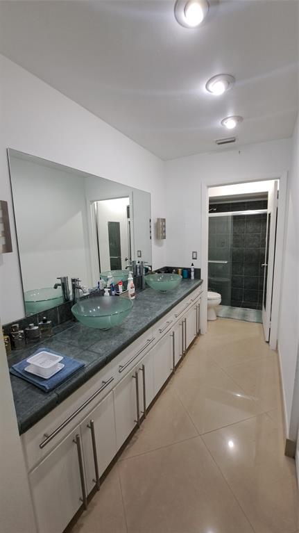 4519 Feivel Road, Unit 46 West Palm Beach, FL 33417 - Photo 23 of 56 a bathroom with double vanity and a mirror