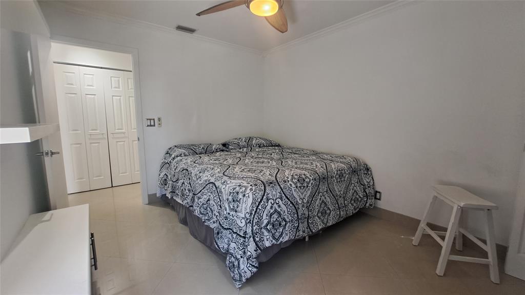 4519 Feivel Road, Unit 46 West Palm Beach, FL 33417 - Photo 34 of 56 a bedroom with a bed and a chair