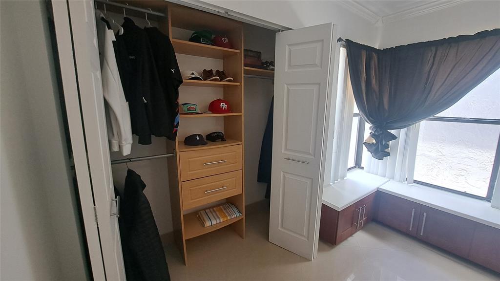 4519 Feivel Road, Unit 46 West Palm Beach, FL 33417 - Photo 36 of 56 a view of walk in closet with clothes and shoes