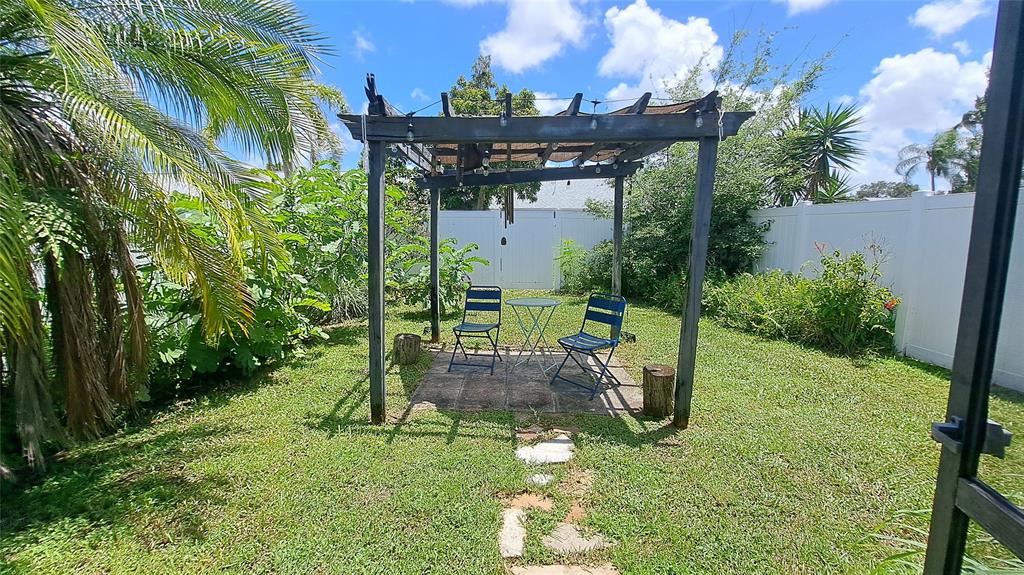 4519 Feivel Road, Unit 46 West Palm Beach, FL 33417 - Photo 46 of 56 a view of a chairs and table in backyard