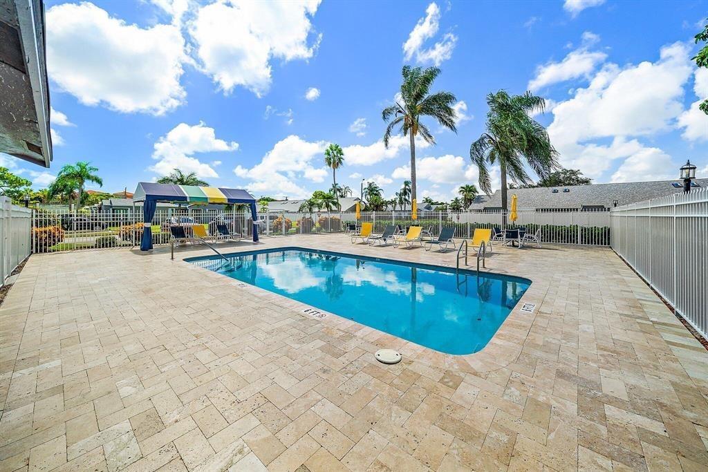 4519 Feivel Road, Unit 46 West Palm Beach, FL 33417 - Photo 47 of 56 a view of swimming pool with outdoor seating and a patio